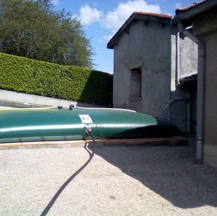 Récupérateur d'eau de pluie installé contre une maison dans les Bouches-du-Rhône